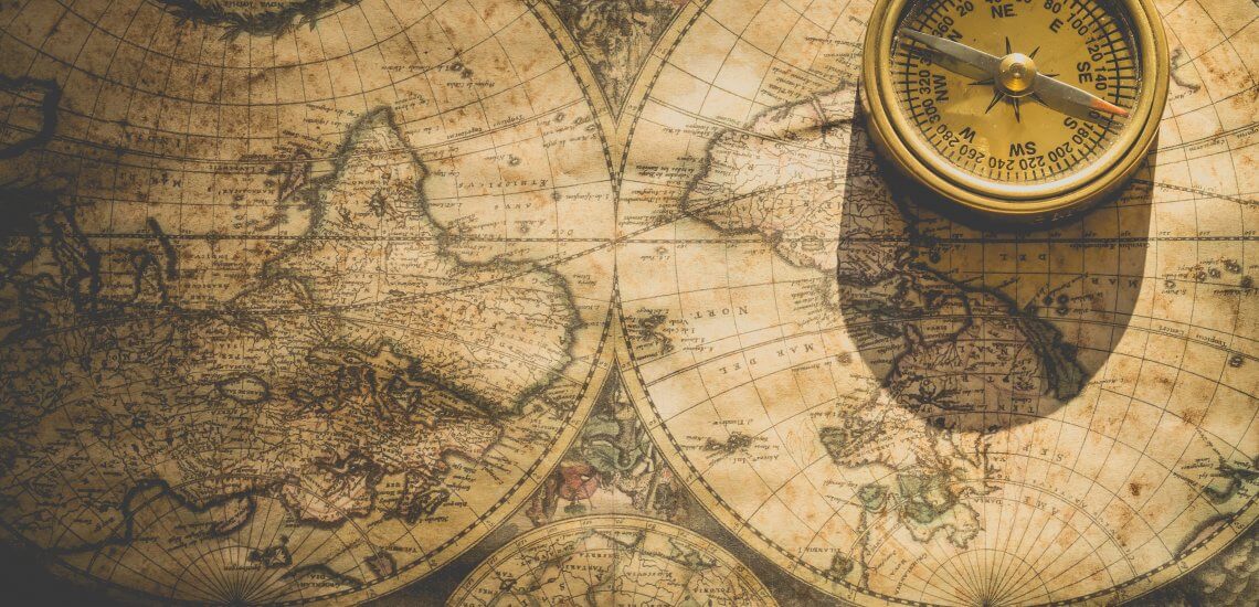 an old world map and a compass
