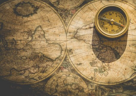 an old world map and a compass